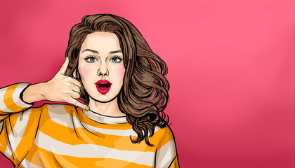 Positive optimistic amazed young woman makes phone gesture of calling, call me back sign, asks for telephone number,wears casual hoodie. Connection communication concept © lucky1984