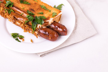 Double hot dogs with french brioche buns and caramelized onions with mayo sauce and ketchup.
