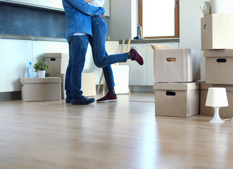 Happy couple hugging in their new house