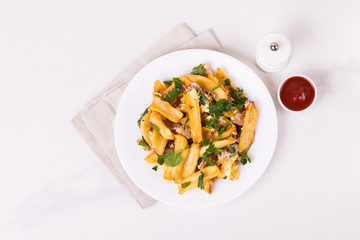 Canadian poutine french fries with brown gravy sauce, chicken and cheese curds.