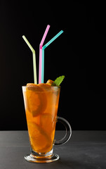 transparent large glass with a handle filled with lemonade with slices of orange