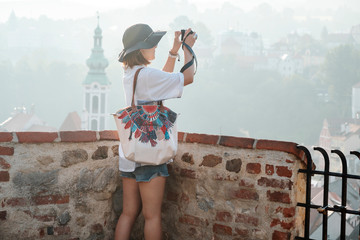 Photographer tourist taking pictures of European city Cesky Krumlov Czech Republic city on a sunny day
