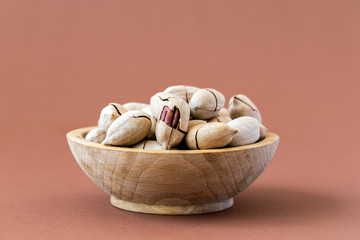 Fototapeta na wymiar Pecan nuts in a wooden plate.Healthy nutrition. Food Vegetarian.