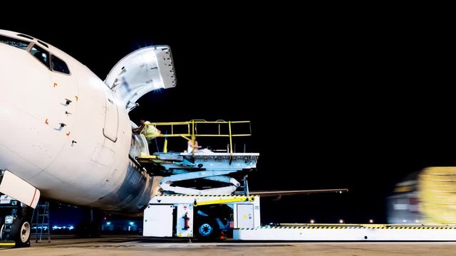 pan aircraft loading cargo timelapse in night