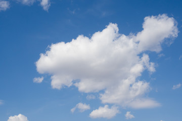 Obraz na płótnie Canvas Blue sky and a huge white cloud. Summer sunny day. Background.