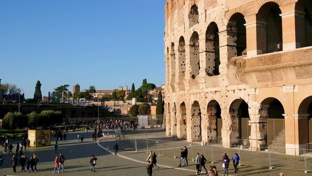Vintage colored view of old coliseum facade with people,enjoy rome city wonders
