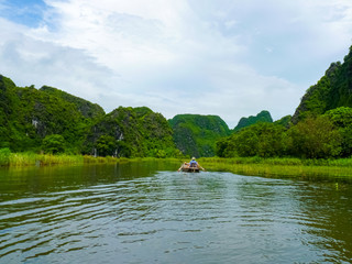 Fototapeta na wymiar Quiet Ride On Peaceful Tam Coc River, Ninh Binh, Vietnam