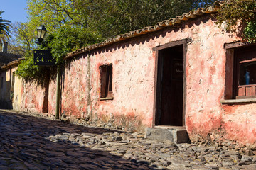 Fototapeta na wymiar Street of Sighs, in the historic center, a World Heritage Site by Unesco in 1995. The houses are from the 18th century. Uruguayan city of Colonia del Sacramento