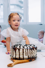 Portrait of cute little girl celebrating third birthday.