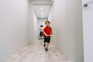 the boy runs down the hall of the house