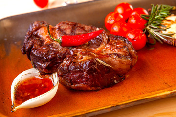 meat dish on a plate with vegetables and spices