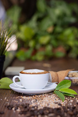 topping cream pattern on a white cub of coffee on a white plate