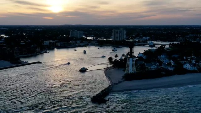 Aerial hyperlapse of beautiful sunset Hillsboro Inlet lighthouse and breakwater, Pampano Beach Florida