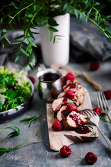 Pork tenderloin with raspberry sauce.