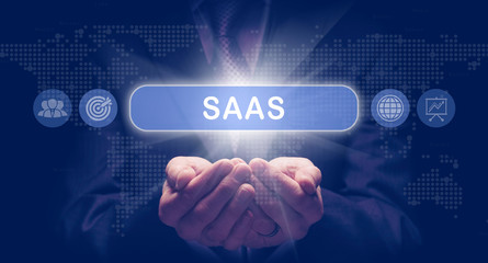 Businessmans cupped hands holding an SaaS business concept on a computerised display.