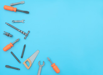 Kids set of working tools on blue background. Father day,  construction industry,  building and repair concept. Flat lay style with copy space for text.