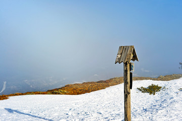 snow covered road sign in the mountains