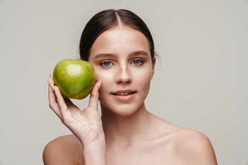 Image of beautiful pleased shirtless woman posing with green apple