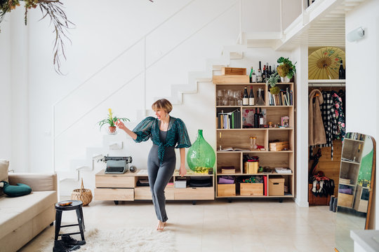 Adult caucasian woman dancing alone indoors at home