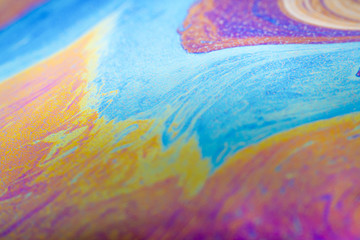 Abstract photo of a soap bubble, iridescent colors on the surface.