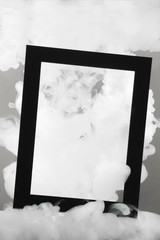 Black frame with white abstract stains of smoke or liquid. Copy space mock up with place for text.