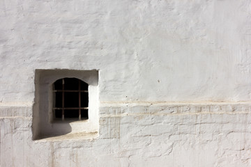 Background of white wall with window and bars. Stone background.