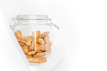 dog cookies in a jar on a light background