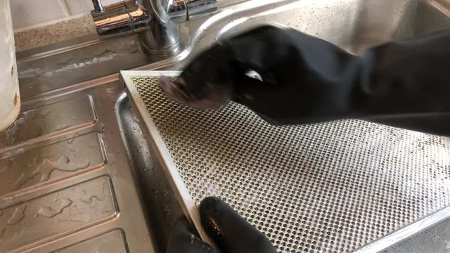 Kitchen cleaning extractor grease filter, close-up, electric