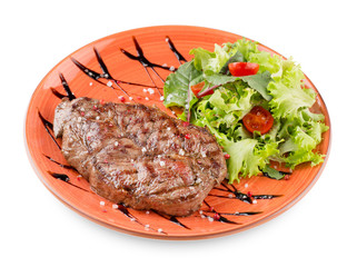 Grilled Beef Steak with salad, tomatoes and sauce on a orange plate Isolated on white