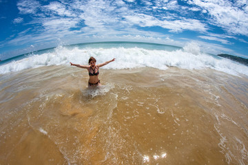 Girl swims in the waves near the shore