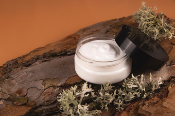The concept of natural and natural cosmetics for personal care. Cream on a tree bark. Top view,...