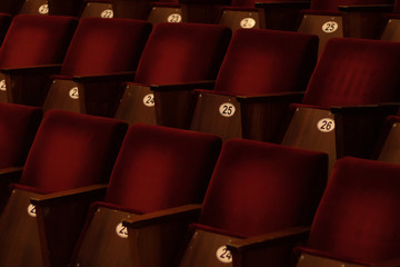 Naklejka na ściany i meble dark red soft velvet chairs in the theater hall