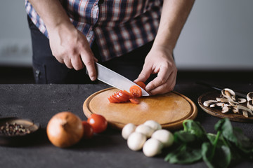 Diet concept, healthy lifestyle, low calorie food. Closeup portrait of man cooking healthy dinner of vegetables and mushrooms