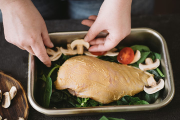 Diet concept, healthy lifestyle, low calorie food. Closeup portrait of woman cooking healthy dinner of chicken meat and mushrooms