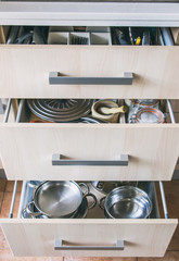 
Open kitchen drawer with utensils. Home