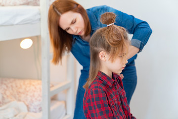 Mom cuts hair at home child during quarantine.