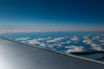 Fototapeta na wymiar View from airplane on blue sky