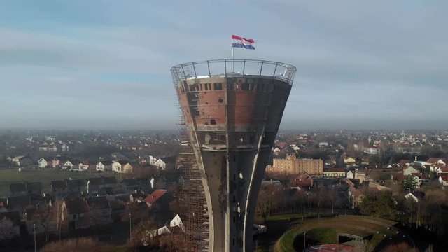 Panorama of the war torn water tower on the edge of the Danube River Vukovar Croatia, Aerial pedestal down