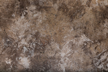 Plastered, painted, rough and beige or light brown concrete or stone wall. High resolution full frame textured background.