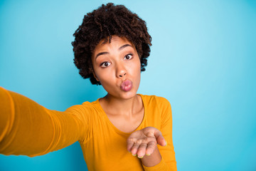 Self-portrait of her she nice attractive lovely sweet pretty cute cheerful wavy-haired girl sending you air kiss affection feelings isolated over bright vivid shine vibrant blue color background