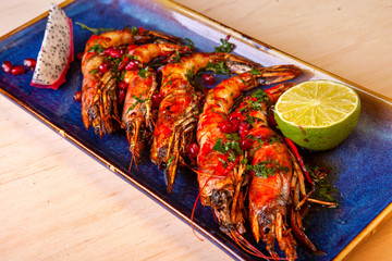 large prawns with lemon on a plate