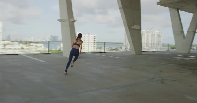 Girl sprinting in concrete garage