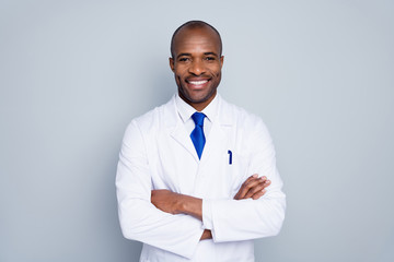 Photo of cheerful doctor dark skin guy virologist agent corona virus seminar conference arms crossed pandemic virus expert wear white lab coat tie isolated grey color background