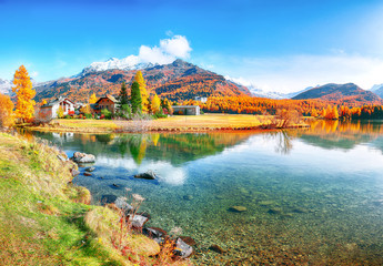 Spectacular autumn scene of Sils im Engadin (Segl) village and  Sils Lake (Silsersee).