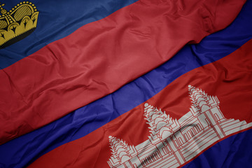 waving colorful flag of cambodia and national flag of liechtenstein.
