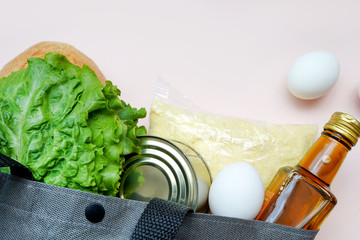 bag with various healthy food on light background, flatlay