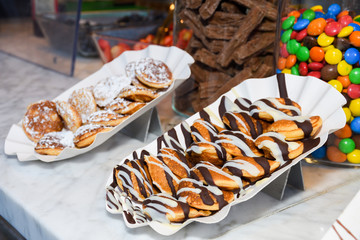 Street food dessert: waffles and small dutch pancakes
