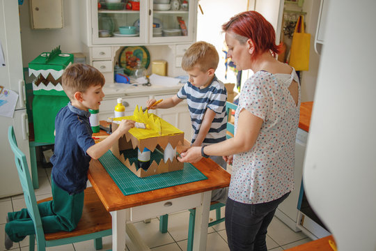 Mom And Kids Making A Cardboard Dinosaur Costume