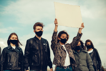 A group of people with mask and posters to protest The protest of the population against...