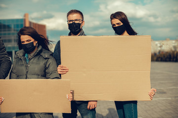 A group of people with mask and posters to protest The protest of the population against...